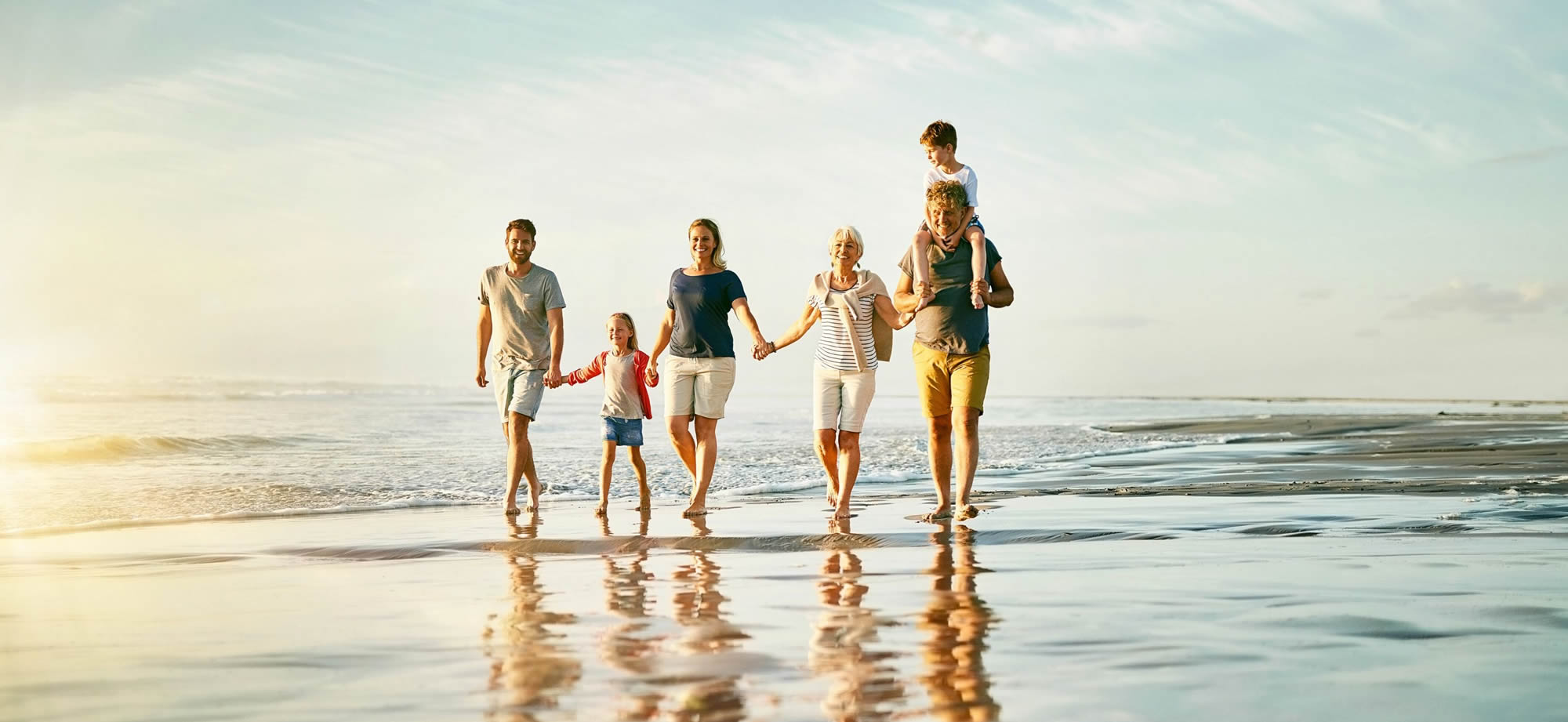 Family walking along Sanderling beach